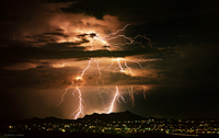 Towering thunderhead during Arizona monsoon season by Warren Faidley